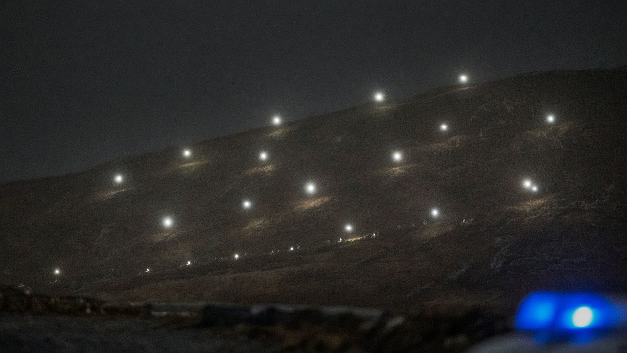 Search grid over a hillside at night